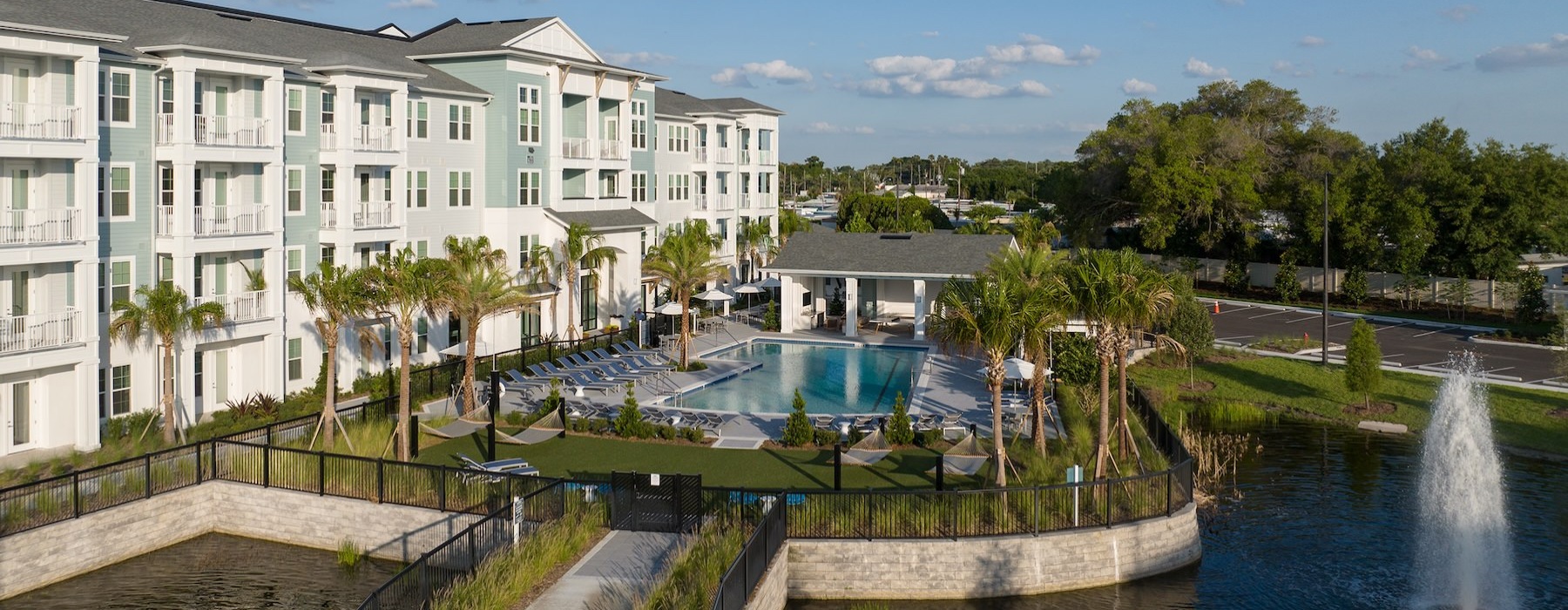 a building next to a pond with a fountain