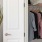 a closet with clothes hanging up