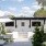 an outdoor kitchen with tvs