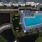 aerial view of pool and pond