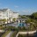 resort style pool with a building and body of water around it