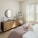 a bedroom with a bed and a mirror
