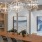a dining room table with chandelier above it