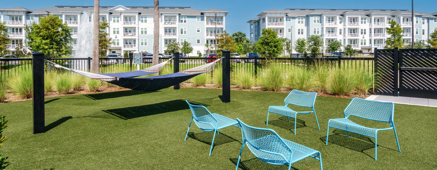 Outdoor seating and hammock lounge area at Solano Belleair apartments in Clearwater, FL