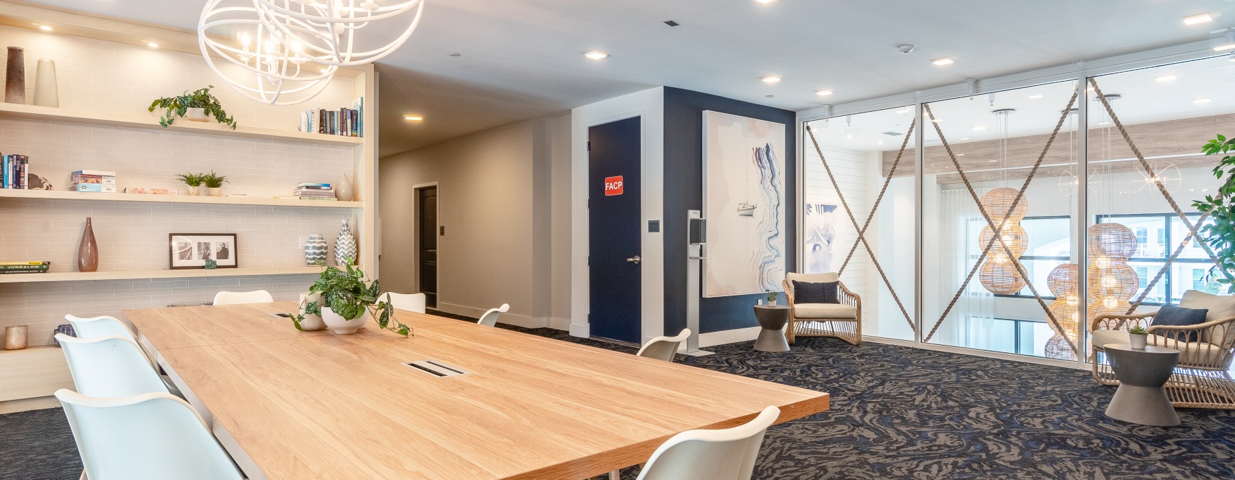 interior clubhouse featuring a large conference table and ample seating areas.